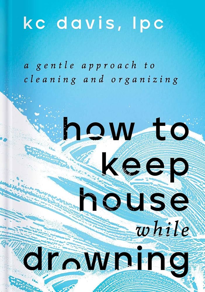 Book cover of 'How to Keep House While Drowning' by KC Davis, featuring a blue background with white wave illustrations and the text in black.