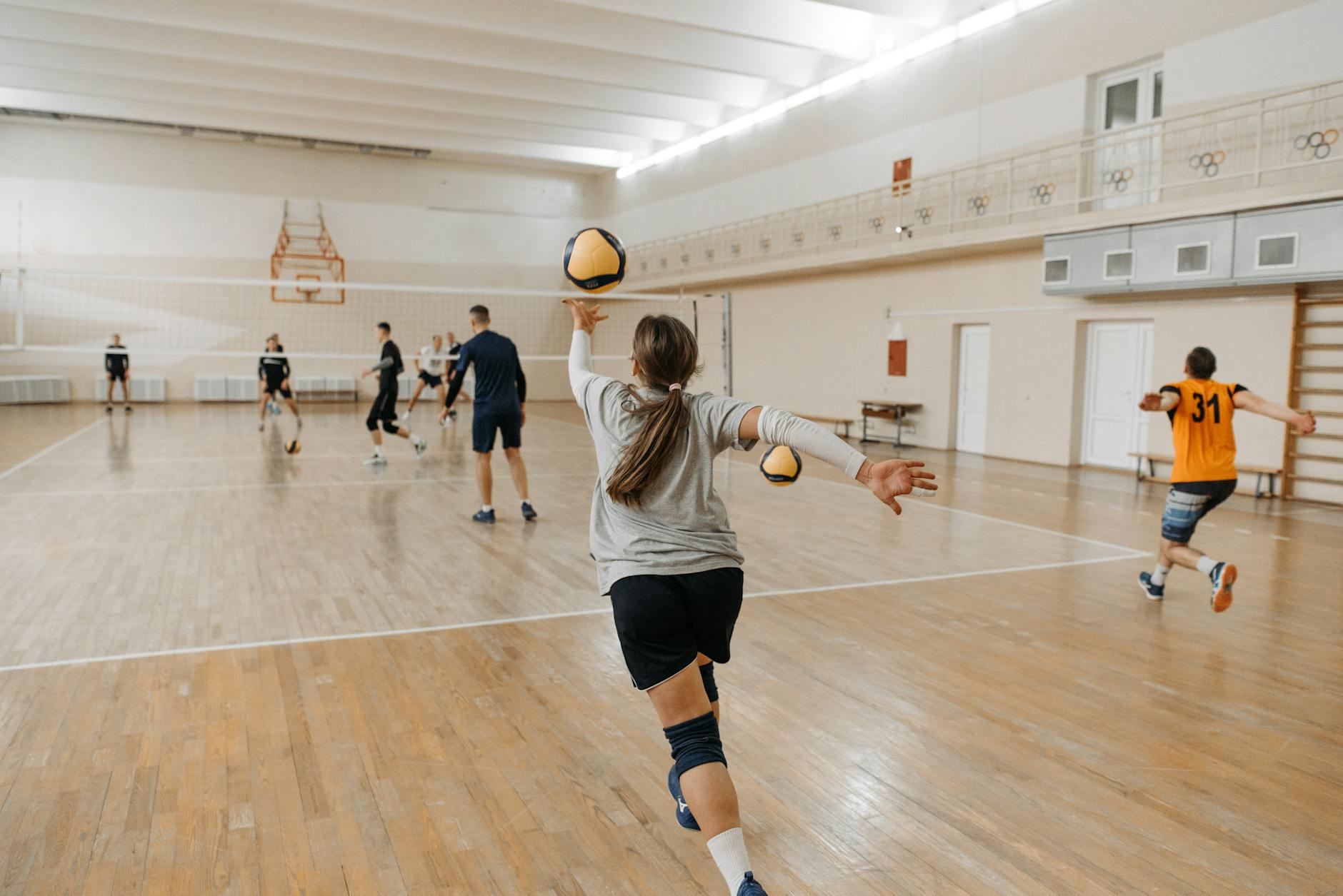 woman in white and black stripe shirt playing basketball